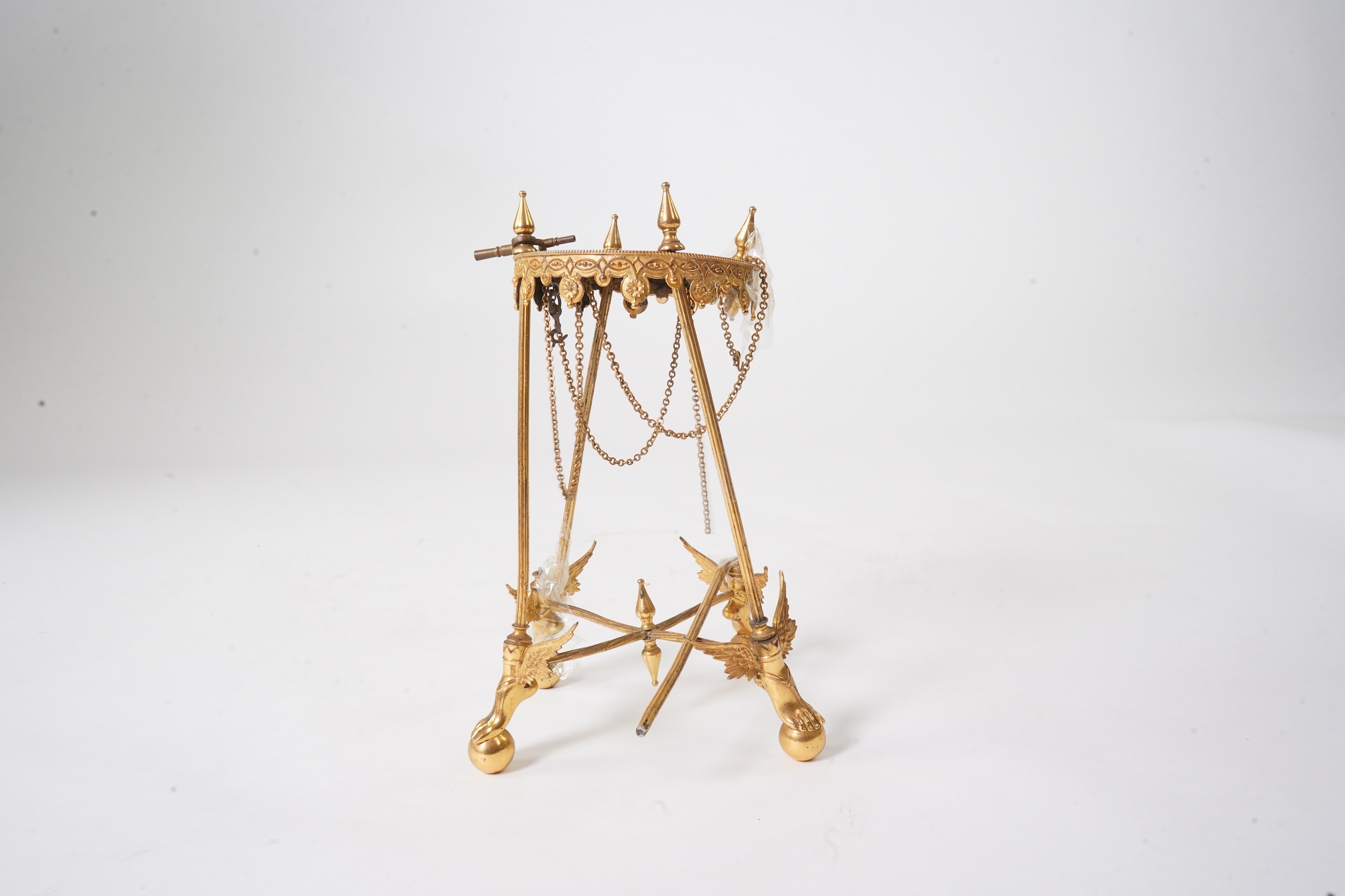 An unusual enamel and gilt brass timepiece, pendant from gilt brass frame, stand 26cm high. Condition - dismantled